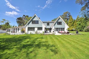 White and Gray Wooden House Near Grass Field and Trees